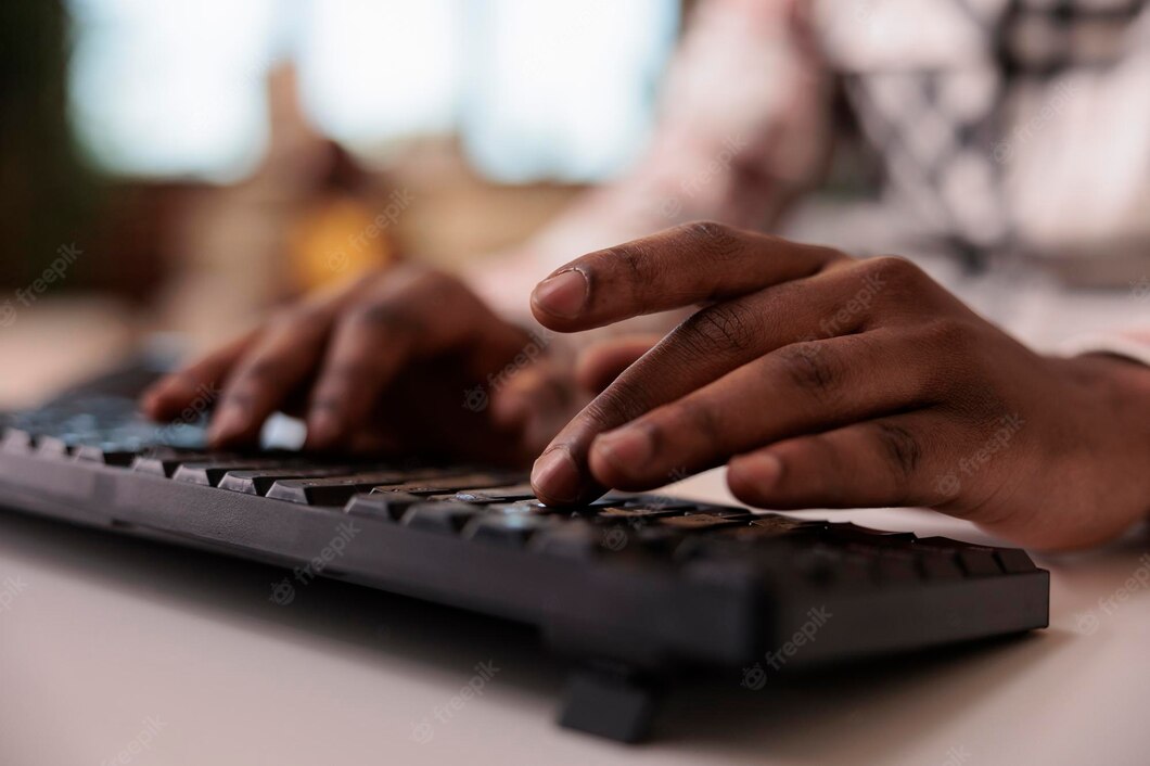 closeup-african-american-male-content-creator-writing-post-social-media-computer-keyboard-home-living-room-selective-focus-man-hands-working-remote-typing-blog-article_482257-43382